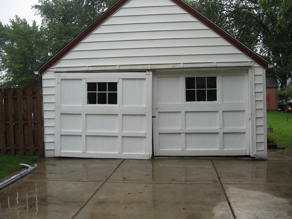 Before garage door repair with rusted and damaged panels in Western New York.